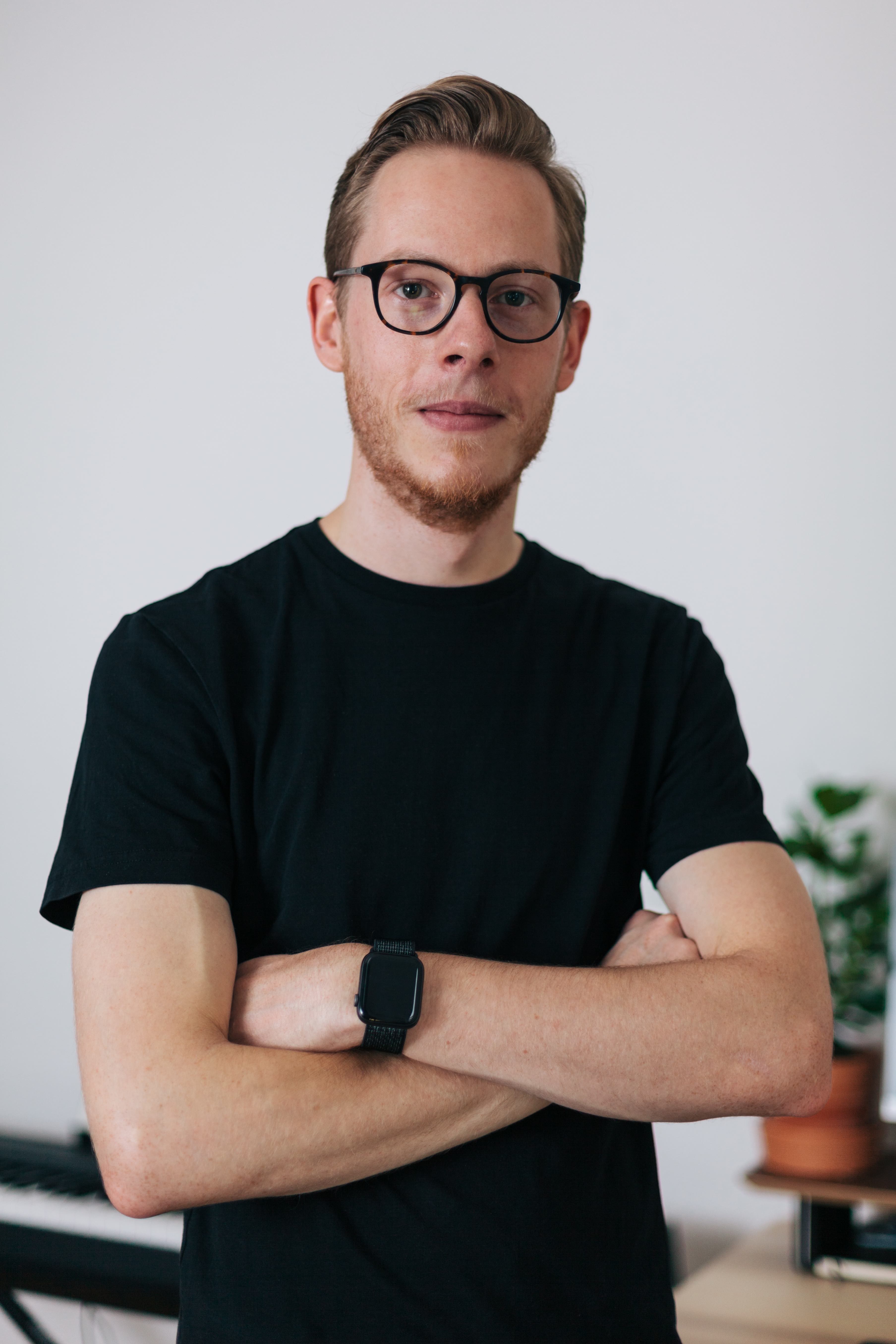 A professional headshot of Marco Meyer standing with arms crossed.